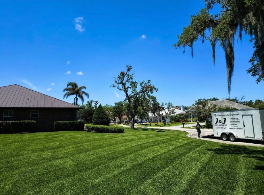 Freshly striped lawn with the J&J Lawn & Landscape trailer on a St. Lucie County property